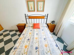 a bedroom with a bed with an orange pillow on it at La Marina in Oropesa del Mar