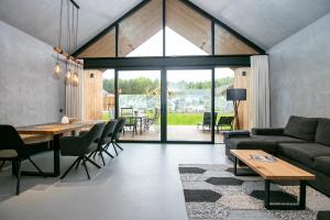 a living room with a couch and a table at Mana Lake in Sieraków
