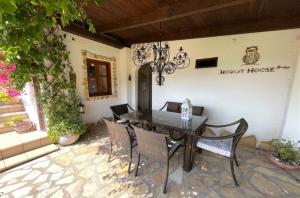 a dining room table and chairs on a patio at Hoolit House in Vournikás