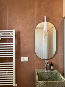 a bathroom with a sink and a mirror at Casa Magenta Holiday in Galatro