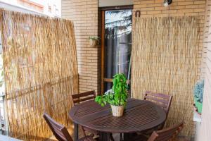 a wooden table with a potted plant on a patio at El Meskiny Apartment Roma in Rome