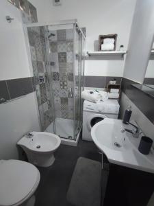 a bathroom with a shower and a toilet and a sink at Little Home in Trani +10 photos