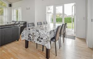 a dining room with a table and chairs and a couch at Holiday Home Juelsminde With A Fireplace 07 in Sønderby +7 photos