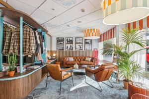 a living room with a couch and chairs at Surf Club Hôtel by Akena - Grande plage in Biarritz