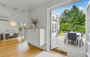 a white dining room with a table and chairs at 3 Bedroom Awesome Home In Vejby in Vejby