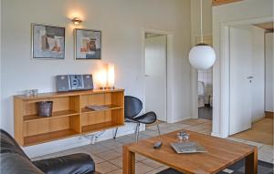 a living room with a couch and a table at 4 Bedroom Lovely Home In Nørre Nebel in Lønne Hede