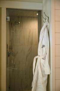 a towel hanging in a bathroom with a shower at Academy Place | Wild Iris in Crested Butte