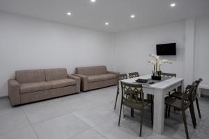 a living room with a table and a couch at Capri Residence in Casoria