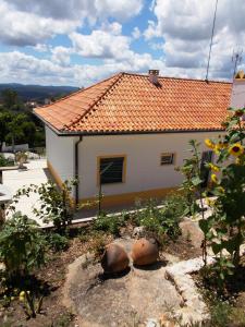 een wit huis met een oranje dak bij Casa do Cabril in Pedrógão Pequeno