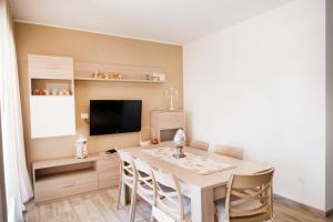a dining room with a table and a television at Marzamemi Relax apartment - Affittimoderni in Marzamemi