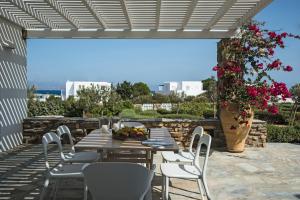 un patio con tavolo, sedie e fiori di Aspro Villas a Piso Livadi