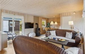a living room with a couch and a table at Amazing Home In Nykøbing Sj With Wifi in Nykøbing Sjælland