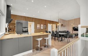 a kitchen and living room with a table and chairs at Beautiful Home In Spøttrup With Wifi in Lihme