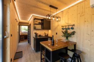 a kitchen with a island in a tiny house at Glamping Pod Lipami in Dolní Bečva