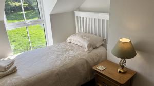 Voodi või voodid majutusasutuse Stables Cottage toas