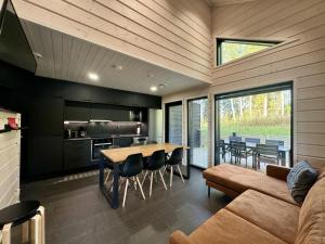 a kitchen and dining room with a table and a couch at Himos Fiesta in Jämsä