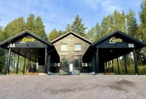 two pavilions with black roofs with the words truth on them at Himos Fiesta in Jämsä