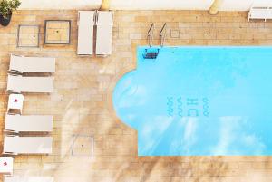 an overhead view of a swimming pool next to a brick wall at Hotel Capri & Residence in Lido di Camaiore