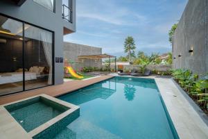 a swimming pool in a house with a playground at Villa Camilia Puncak in Bogor