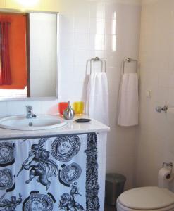 a bathroom with a sink and a toilet and a mirror at Monte da Xara in Aljezur