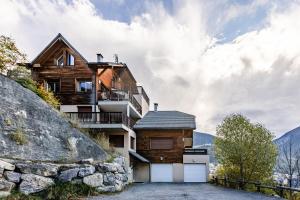 a house on the side of a mountain at Les 5 Vallées - Appt en Duplex avec vue montagne in Briançon