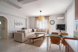 a living room with a couch and a table at Luxury apt near the airport N2 in Spáta