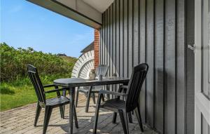 a black table and chairs on a patio at Fanø Bad, Lejl 15 in Fanø