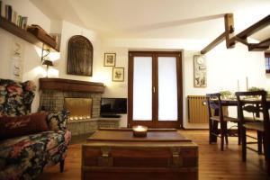 a living room with a couch and a fireplace at Maison de Charme Courmayeur in Courmayeur