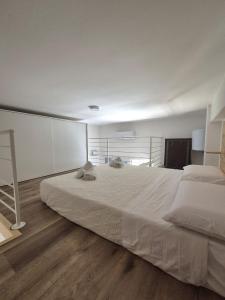 a bedroom with a large white bed in a room at Loft piano terra a 300m dal mare in Terracina