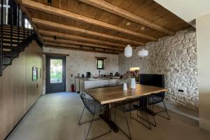 a large kitchen with a wooden table and chairs at Lithero Suites in Stemnitsa