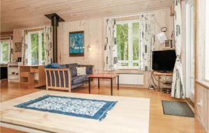 a living room with a couch and a table at Holiday Home Ruggårdsvej Højby Denm in Lumsås