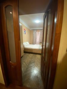 a room with a bed and a sliding glass door at Акуратні апартаменти в центрі Львова in Lviv +5 photos