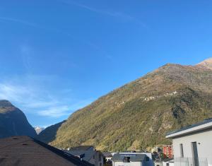a view of a mountain with houses and buildings at the AllSun in Tirano