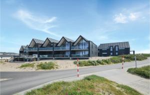 a building on the beach with a road in front at Two-Bedroom Apartment In Thisted in Thisted +23 photos