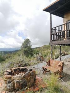 a wooden bench sitting outside of a building at Mountain Glamping - Nature and Relax in Fúquene