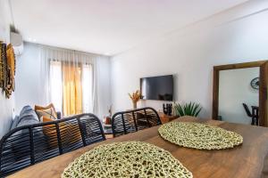 a dining room with a table with chairs and a couch at Bohemian Style in hyper-center - Wifi in Marrakesh +4 photos