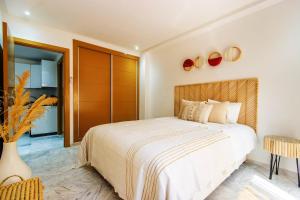 a bedroom with a large bed in a room at Bohemian Style in hyper-center - Wifi in Marrakesh