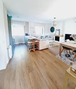 a living room with a couch and a table at Vivienda Pantano de San Juan in San Martín de Valdeiglesias +38 photos