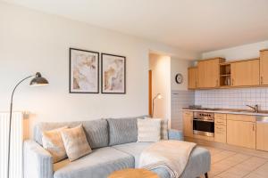 a living room with a couch and a kitchen at Ferienwohnung Tannenblick 2-1 in Oberhof