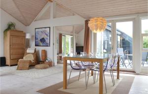 a dining room with a glass table and chairs at Two-Bedroom Holiday Home With A Fireplace In Sjællands Odde in Yderby