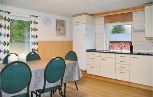 a kitchen and dining room with a table and chairs at 3 Bedroom Cozy Home In Kristinehamn in Edet