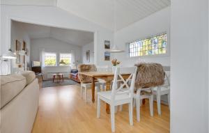 a dining room and living room with a table and chairs at 2 Bedroom Beautiful Home In Gilleleje in Gilleleje