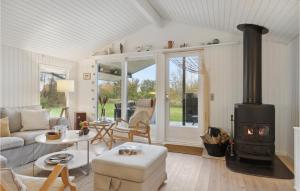 a living room with a couch and a stove at Cozy Home In Skagen With Kitchen in Skagen