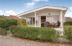 a small white house with a porch at Three-Bedroom Holiday Home In Haderslev in Haderslev