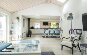 a living room with a couch and a table at Amazing Home In Nexø With Sauna in Neksø