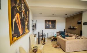 a living room with a large painting on the wall at Villa Avia Milatos Crete in Milatos