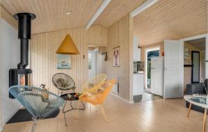 a living room with chairs and a table and a stove at Lovely Home In Slagelse With Wifi in Slagelse