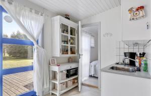 a small kitchen with a sink and a window at 2 Bedroom Lovely Apartment In Nexø in Neksø