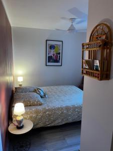 a bedroom with a bed and a table with a lamp at Villa Simone proche Uzes et pont du Gard in Blauzac +36 photos