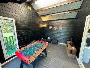 a room with a table in the corner of a room at Rural Retreat with Hot Tub, Fire Pit & Games Room in Sheffield